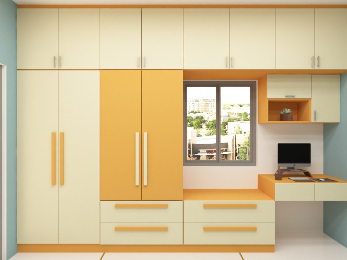 Cream and yellow kids wardrobe with attached study desk and open shelves