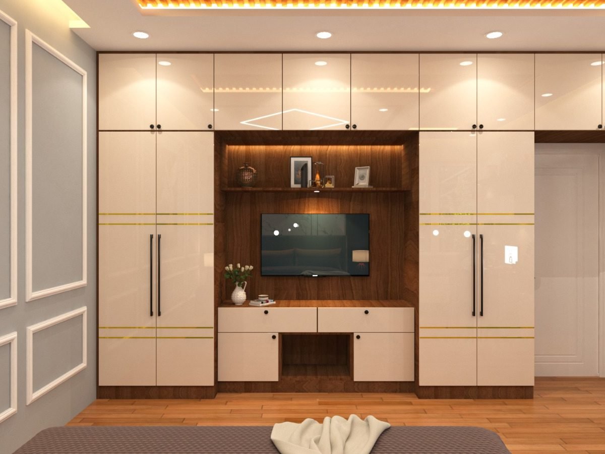 Ivory and wood TV unit flanked by full height wardrobe storage in a bedroom